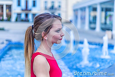 Beautiful young business woman sitting at the city square Stock Photo