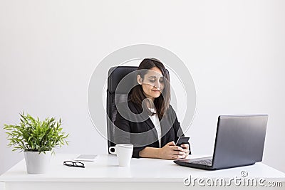 beautiful young Business woman working in the office, using her laptop and mobile phone. Business Concept.white backgrounds. Stock Photo