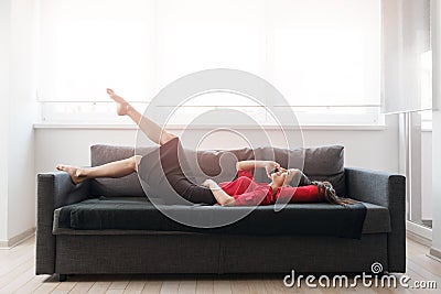 Beautiful young businesswoman talking over the phone on a sofa Stock Photo