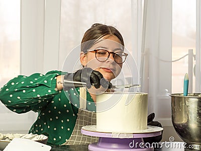 Confectioner girl makes a cake Stock Photo
