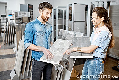 Couple choosing ceramic tiles in the shop Stock Photo
