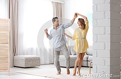 Beautiful couple dancing in living at home Stock Photo
