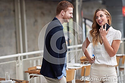 Beautiful young caucasian couple flirting in a modern restaurant. smiling, looking each other Stock Photo