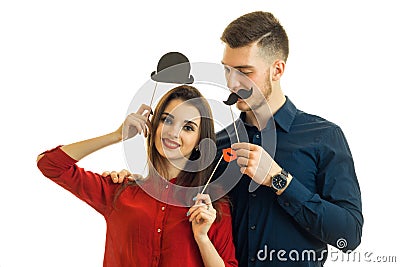 Beautiful young couple smiling and carrying paper props for photo Stock Photo