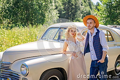 Beautiful young couple standing by the car Stock Photo