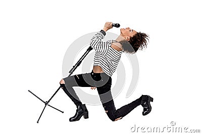 Beautiful young emotional heavy metal singer with microphone singing Stock Photo