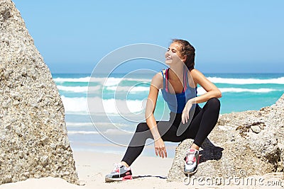 beautiful young exercise woman relaxing at the beach Stock Photo