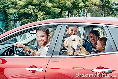 beautiful young family travelling by car Stock Photo