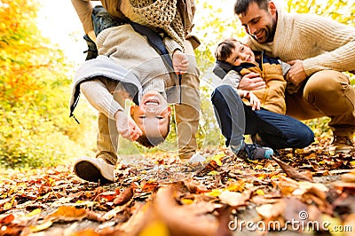 Beautiful young family on a walk in autumn forest. Stock Photo