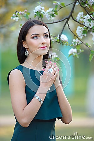 Beautiful young fashion model with with long hair wearing jewelry luxury jewelry and accessory. Spring collection. Beauty fashion Stock Photo