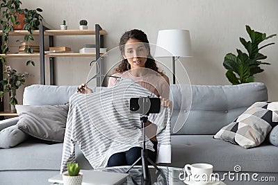 Beautiful young female blogger recording shopping video. Stock Photo