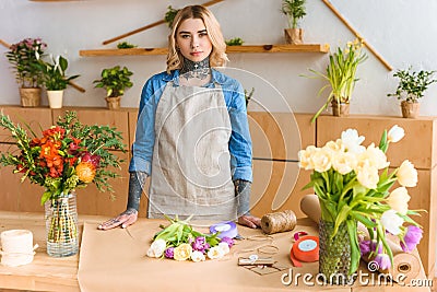 beautiful young female florist with tattoos looking at camera Stock Photo