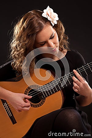 Beautiful young female guitar player Stock Photo