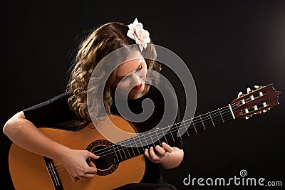 Beautiful young female guitar player Stock Photo