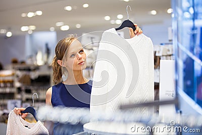 Beautiful young female shopper in a clothing store Stock Photo