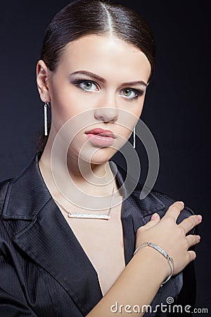 Beautiful young girl with beautiful stylish expensive jewelry, necklace, earrings, bracelet, ring, filming in the Studio Stock Photo