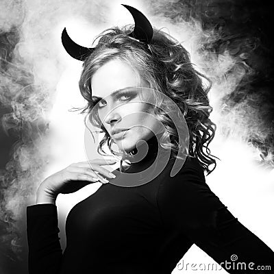 The beautiful young girl a devil Stock Photo