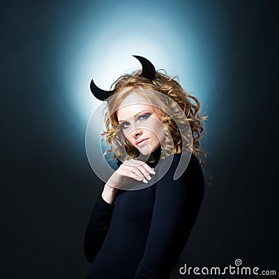 The beautiful young girl a devil Stock Photo