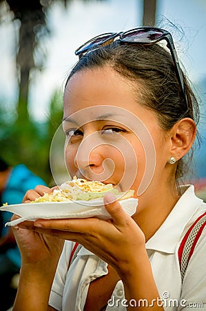 Beautiful young girl eating a tostada soft taco Stock Photo