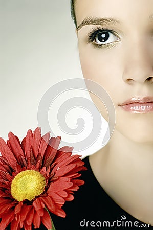 Beautiful young girl with gerber flower Stock Photo