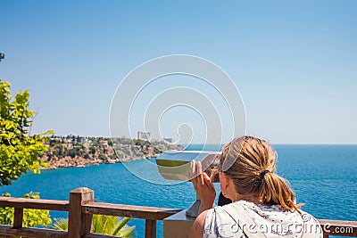 Beautiful and young girl looking through binoculars Stock Photo