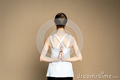 A beautiful young girl is meditating in the pose of Parshvottanasana. Marichiasana. Consideration and praying Stock Photo