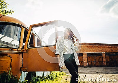 Beautiful young girl poses near retro car Stock Photo