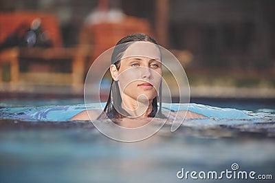 Beautiful young girl swim in a blue pool Stock Photo