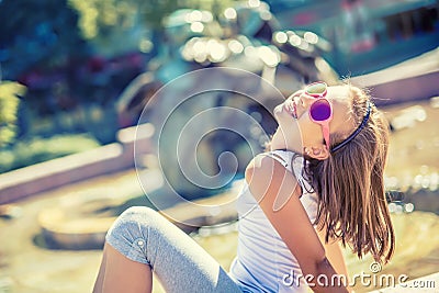 Beautiful young girl teen outdoor. Happy pre-teen girl with braces and glasses. Summer hot day Stock Photo