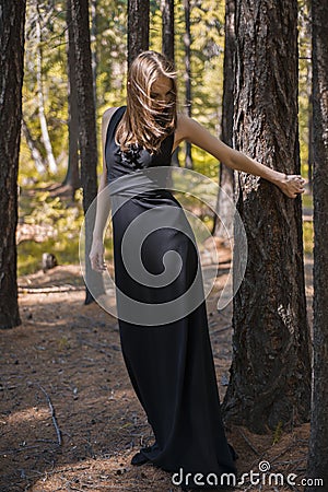 Beautiful young girl walking in a fairy forest. Stock Photo