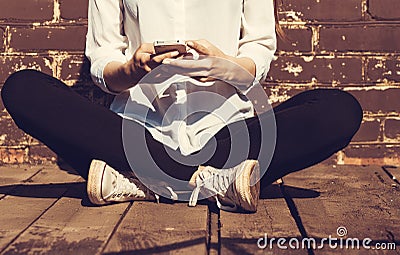 Beautiful young hipster woman using smart phone Stock Photo