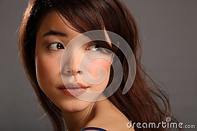 Beautiful young Japanese girl looking away Stock Photo