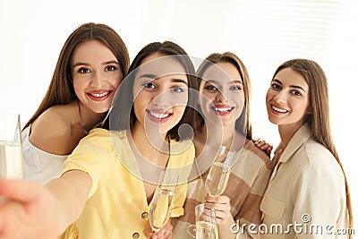 Beautiful young ladies with champagne taking selfie. Woman`s Day Stock Photo