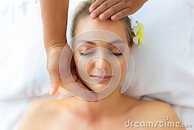 Beautiful young lady feel relaxing, happiness and relief from stress when massager massage on her beautiful face at spa salon. Cha Stock Photo