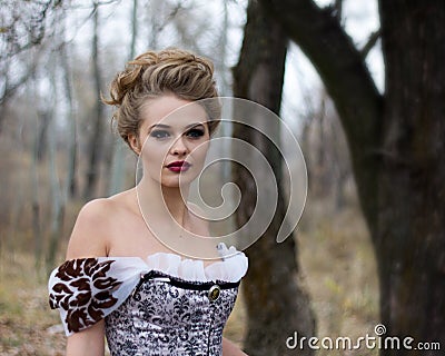 Beautiful young lady in gorgeous vintage dress. Portrait outdoo Stock Photo