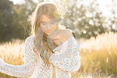 Beautiful young lady model in field at sunrise Stock Photo
