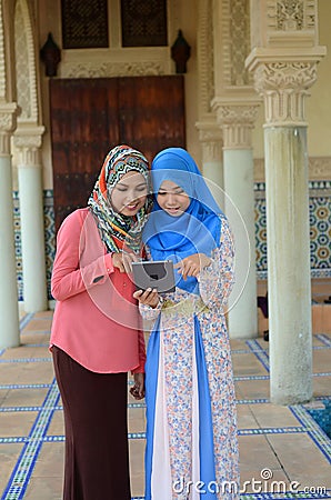 Beautiful young muslim student sharing info together Stock Photo