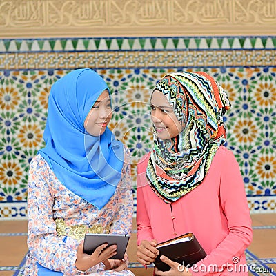 Beautiful young muslim student sharing info together Stock Photo