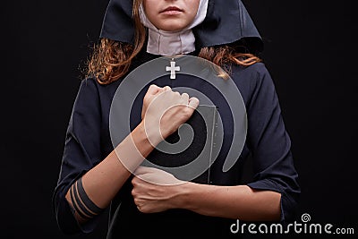 Pretty religious nun in religion concept against dark background. Stock Photo