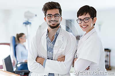 Beautiful young ophthalmologists in modern professional clinic Stock Photo