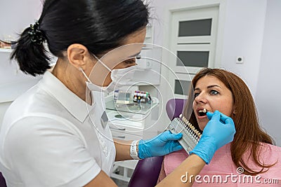 beautiful young patient came to a female dentist for caries treatment. Stock Photo