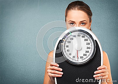 Beautiful young s woman holding scales Stock Photo