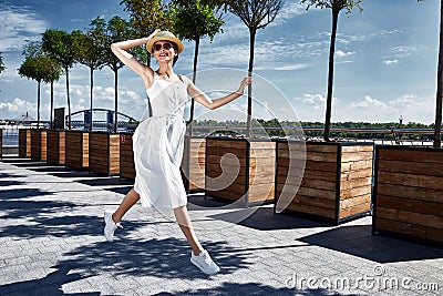 Beautiful young brunette woman dressed white cotton sarafan Stock Photo