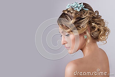 Beautiful young elegant sweet girl in the image of a bride with hair and flowers in her hair , delicate wedding makeup Stock Photo