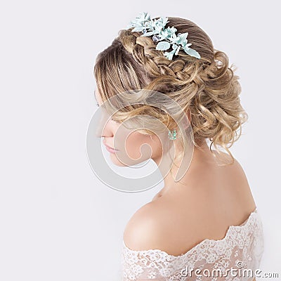 Beautiful young elegant sweet girl in the image of a bride with hair and flowers in her hair , delicate wedding makeup Stock Photo