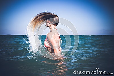 Beautiful young womanhaving fun in refreshing sea water. Bali island. Stock Photo