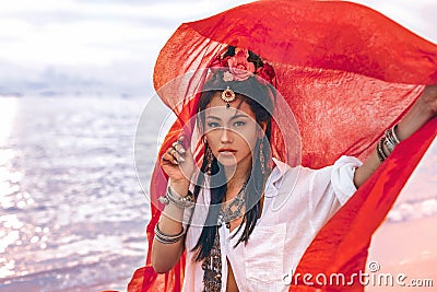 Beautiful young stylish woman on the beach at sunset Stock Photo