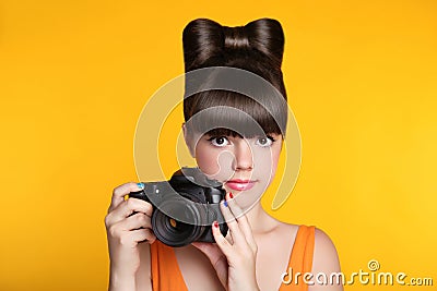 Beautiful young teen girl with camera taking a photo. Pretty mod Stock Photo