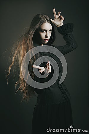 Beautiful young witch casting a spell Stock Photo