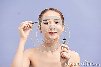 Beautiful young woman applied mascara, studio beauty portrait Stock Photo